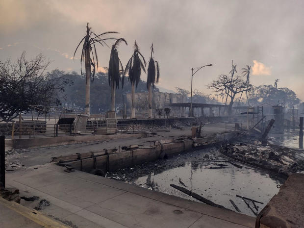 A charred boat lies in the scorched waterfront after wildfires fanned by the winds of a distant hurricane devastated Maui's city of Lahaina, Hawaii, August 9, 2023. 