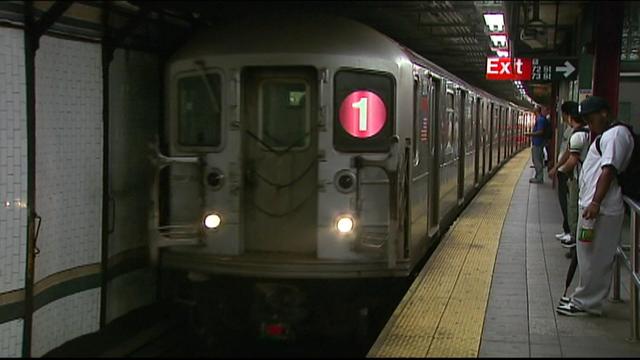 A 1 train pulls into a subway station. 