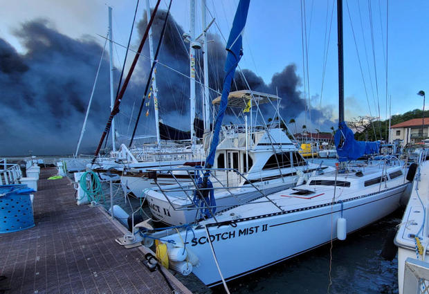 Smoke billows near boats docked at Lahaina as wildfires driven by high winds destroy a large part of the historic town on the Hawaiian island of Maui, August 9, 2023. 