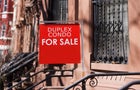 american economy: home for sale sign on city residential street 