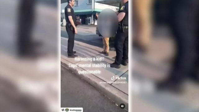 A screenshot of a TikTok video showing two white Yonkers Police officers talking to a Black child. A caption on the video says, "Harassing a kid!! Cops' mental stability is questionable." 