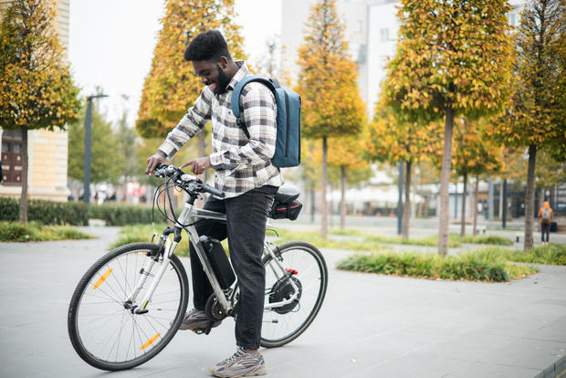Portrait of an African American man going to work on an electric bicycle 