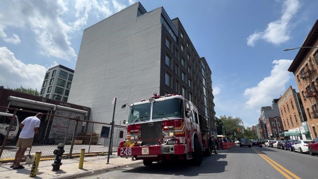 A fire truck parked in front of a building in Brooklyn. 