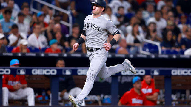 Billy McKinney #57 of the New York Yankees runs home to score a run against the Miami Marlins during the seventh inning at loanDepot park on August 12, 2023 in Miami, Florida. 