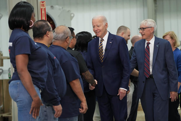 President Biden and Wisconsin Gov. Tony Evers are greeted by workers as they arrive at Ingeteam Inc. in Milwaukee on Tuesday, Aug. 15, 2023. 