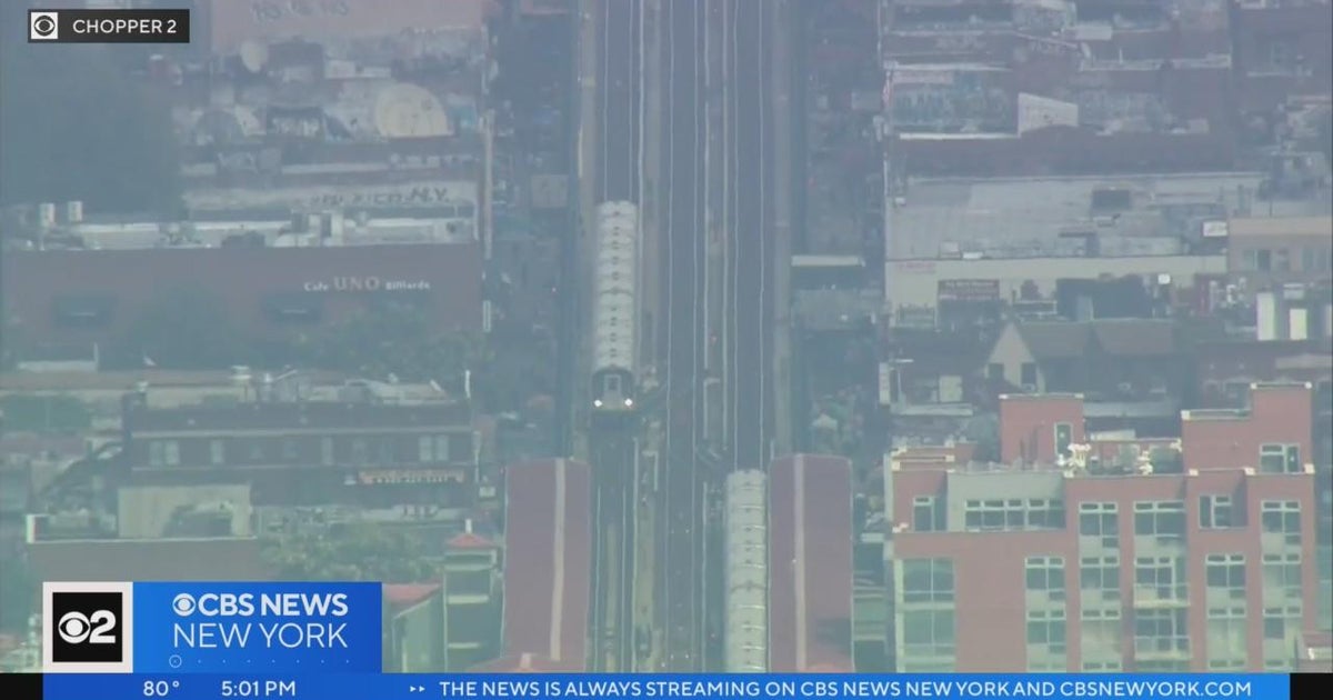 NYPD investigates after woman pushed onto subway tracks in Queens - CBS ...