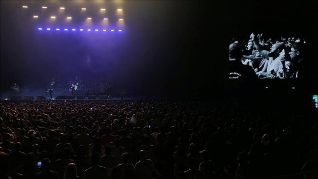 People in the audience are seen on a large screen as they boo during a concert by American alternative-rock band The Killers after lead singer Brandon Flowers invited a Russian drummer to the stage, in Batumi, Georgia, August 15, 2023, in this picture obtained from social media video