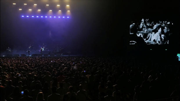 People in the audience are seen on a large screen as they boo during a concert by American alternative-rock band The Killers after lead singer Brandon Flowers invited a Russian drummer to the stage, in Batumi, Georgia, August 15, 2023, in this picture obtained from social media video. 
