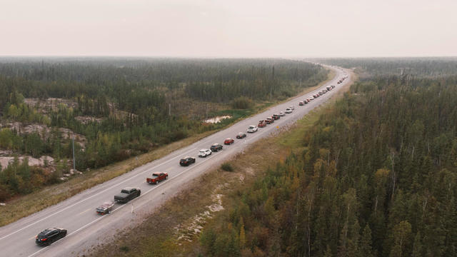Yellowknife residents leave the city on Highway 3, the only highway in or out of the community, after an evacuation order was given due to the proximity of wildfires in Yellowknife, Northwest Territories, on August 16, 2023. 