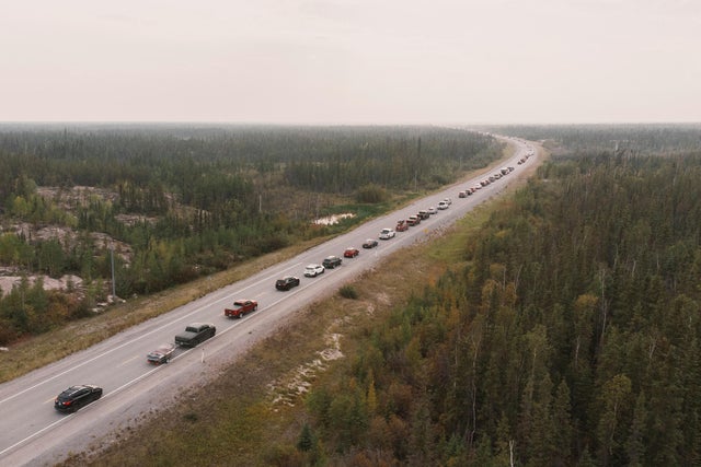 Yellowknife residents leave the city on Highway 3, the only highway in or out of the community, after an evacuation order was given due to the proximity of wildfires in Yellowknife, Northwest Territories, on August 16, 2023. 