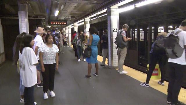 Commuters stand on the subway platform at the 23rd Street station in Manhattan. 