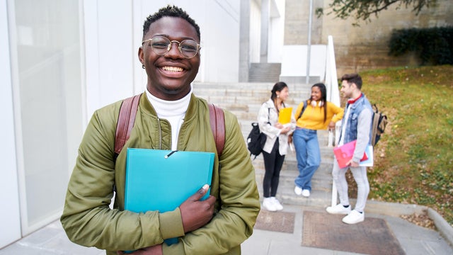 Happy African American young men looking at the camera out at the university campus. 
