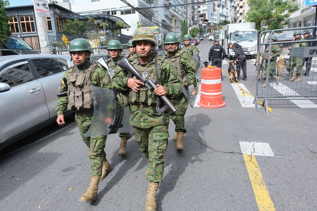 Members of the military patrol outside a polling station during the presidential elections in Quito, Ecuador, on Sunday, Aug. 20, 2023