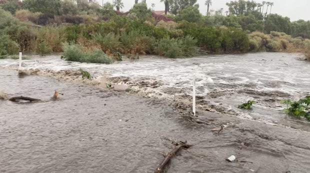 A view shows flood water moving across the road during Tropical Storm Hilary, in Palm Springs