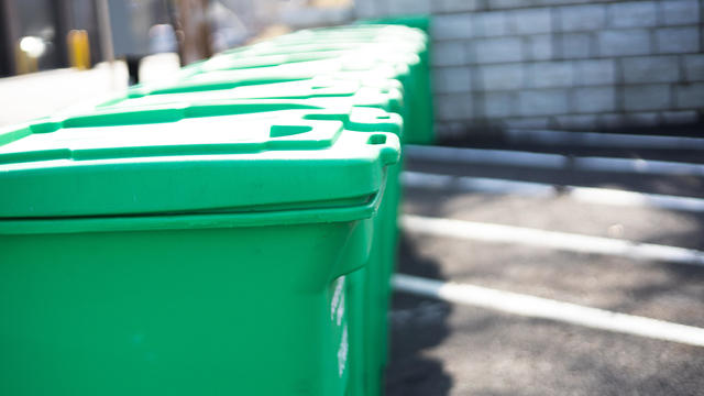 row of municipal green community composting bins 