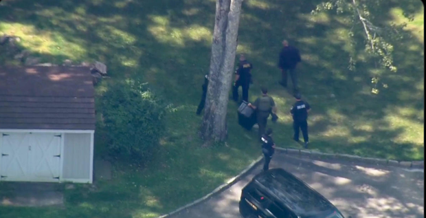 Officials are seen approaching the Westchester residence where a 7-year-old boy was attacked by a bear on August 21, 2023.