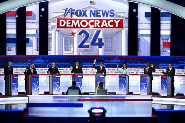 GOP candidates raise their hands to indicate they would support former President Donald Trump as the Republican nominee if he was convicted of a crime on Wednesday, Aug. 23, 2023.
