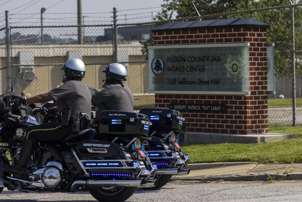 Law enforcement officers patrol the perimeter of the Fulton County jail in Atlanta, Georgia, on Tuesday, Aug. 22, 2023.