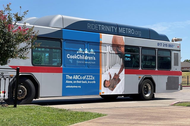 Ad on a city bus promoting safe infant sleep practices 