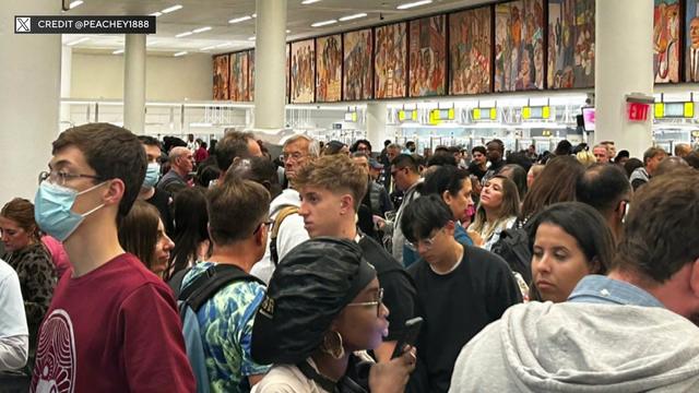 People wait in long lines at customs at JFK Airport. 
