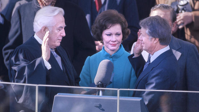 U.S. President Jimmy Carter with wife Rosalynn and Chief Justice Warren E. Burger, taking oath of office of President of the United States from, East Portico of U.S. Capitol, Washington, D.C., USA, Bernard Gotfryd, January 20, 1977 