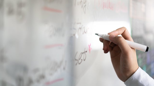 young man using white board in office 