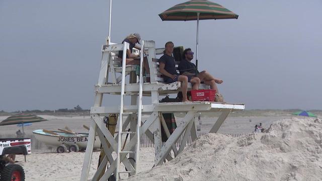 Lifeguards sit on a lifeguard stand at Jones Beach 