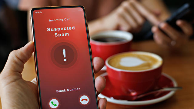 Person receiving suspected spam call on smartphone from an unknown caller 