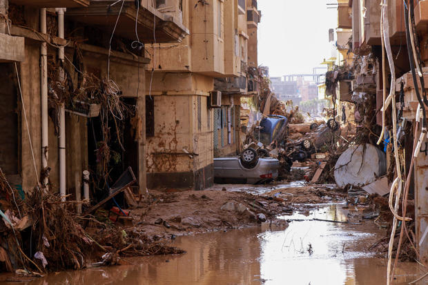 Overturned cars lie among other debris caused by flash floods in Derna, eastern Libya, on September 11, 2023. 