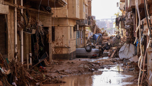 Overturned cars lie among other debris caused by flash floods in Derna, eastern Libya, on September 11, 2023. 