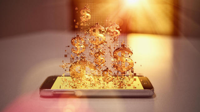 Pixelated dollar signs floating over cell phone 