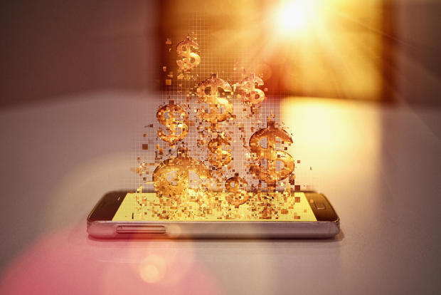 Pixelated dollar signs floating over cell phone 