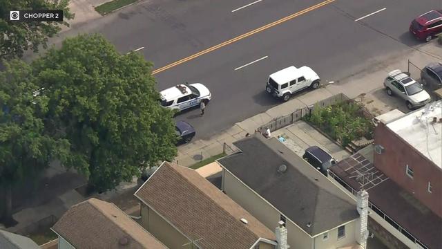 An aerial view of a police vehicle and several parked cars in Brooklyn. 