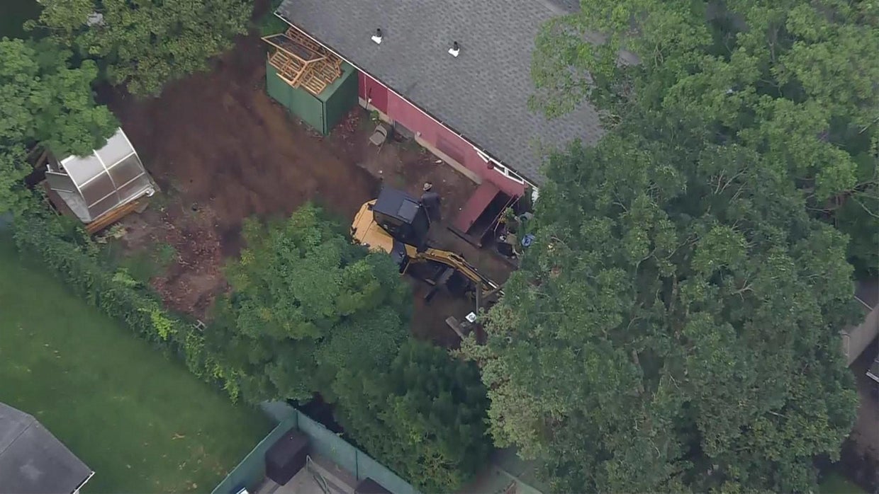 Excavator at Heuermann home