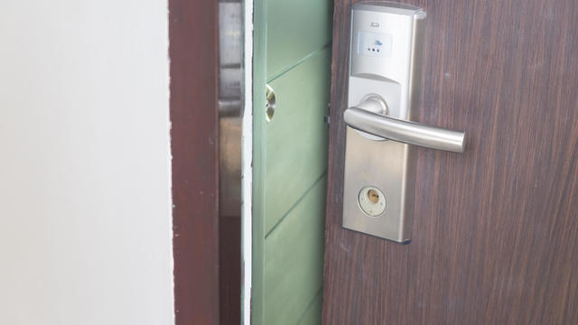 Hotel door with keyless entry card on wood door 