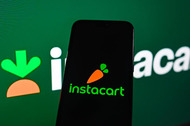 In this photo illustration, the Instacart logo seen 