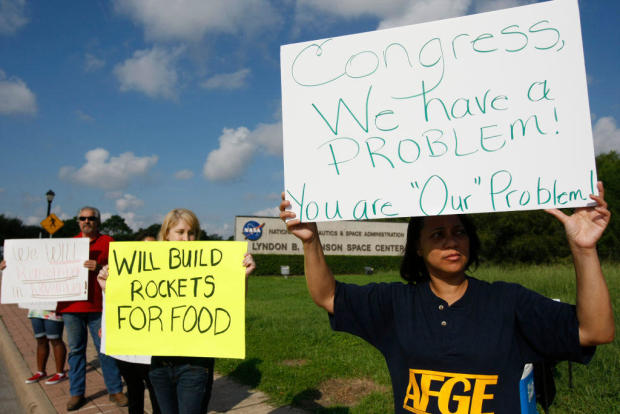 Federal employees express their disappointment with Congress' inability to end the federal government shutdown on Tuesday, Oct. 15, 2013, in Houston. 