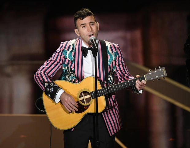 Sufjan Stevens playing the guitar