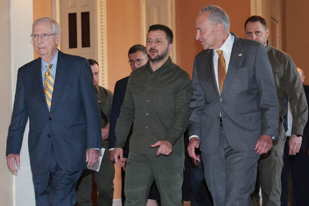 Ukrainian President Volodymyr Zelenskyy gestures while walking with Senate Majority Leader Chuck Schumer and Minority Leader Mitch McConnell at the Capitol on Sept. 21, 2023. 