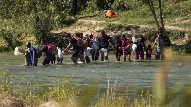 Migrants cross the Rio Grande from Mexico into the U.S. on Thursday, Sept. 21, 2023, in Eagle Pass, Texas. 
