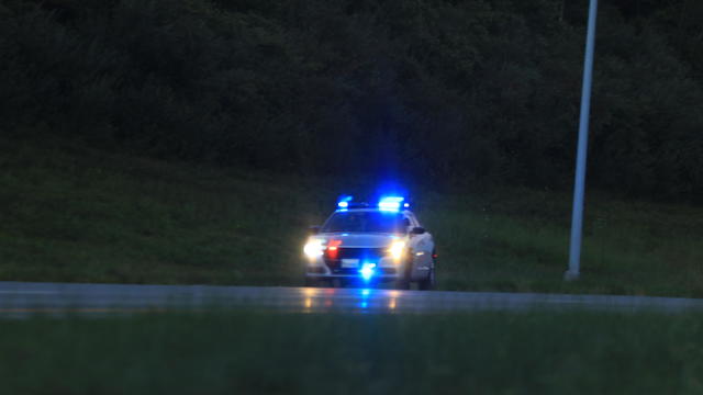 Illuminated police car lights and sirens 