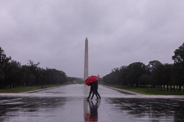 People walk through the rain on the steps of the Lincoln Memorial on Sept. 23, 2023, in Washington, D.C. 
