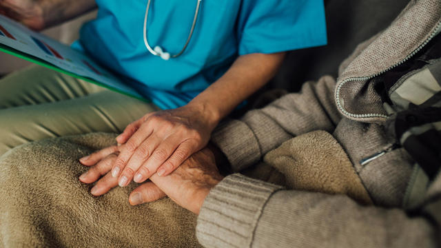Nurse holding patient's hand 