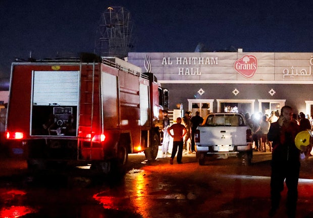 People gather at the site following a fatal fire at a wedding celebration, in the district of Hamdaniya, in Iraq's Nineveh province, Sept. 27, 2023