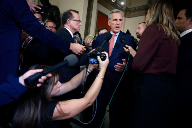 House Speaker Kevin McCarthy pauses to talk to reporters at the Capitol as he heads to the House chamber for a vote on Sept. 27, 2023. 