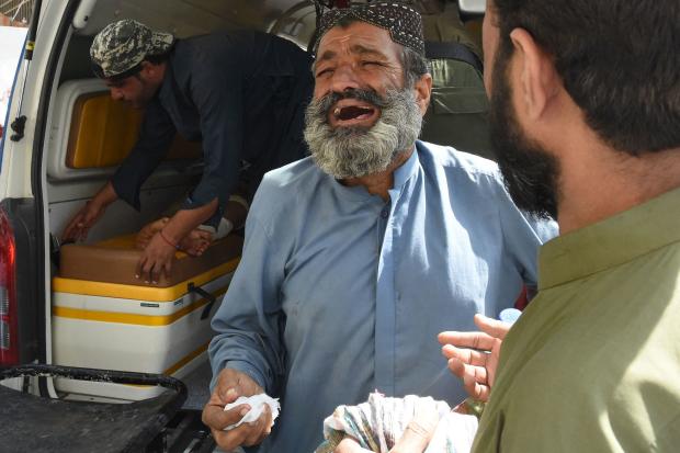 A relative mourns a victim of a suicide attack, at a hospital in Quetta, Pakistan, Sept. 29, 2023, after a bomber targeted a procession marking the birthday of Islam's Prophet Mohammed in Balochistan province's Mastung district