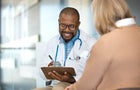 Doctor discussing with patient in hospital 