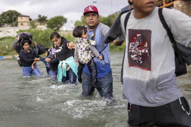 Immigrants from Venezuela cross the Rio Grande from Mexico into the U.S. on Sept. 30, 2023, in Eagle Pass, Texas. 