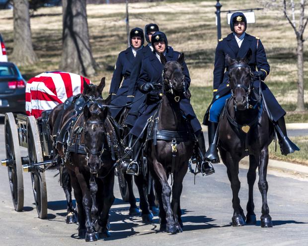Burial at Arlington National Cemetery with coffin carried on horse drawn caisson 