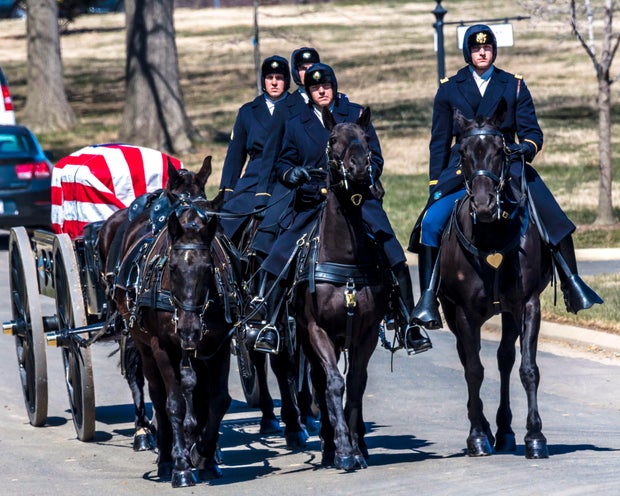 Burial at Arlington National Cemetery with coffin carried on horse drawn caisson